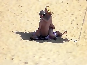 Young couple gets horny on the beach