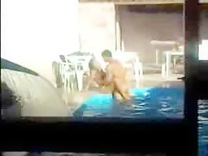 Voyeur spies on a couple fucking in the pool